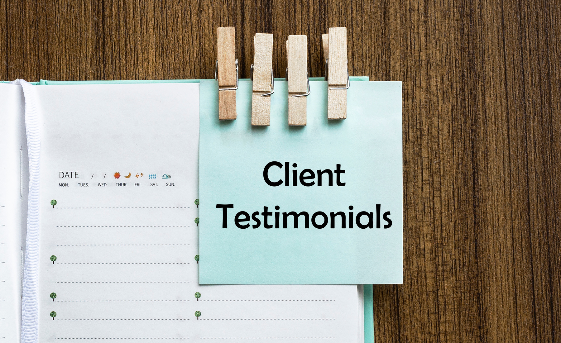 Client Testimonials notes paper and a clothes pegs on wooden background